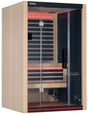 A light brown colored home sauna that fits 2 people. There are lights on inside and the lights are red.