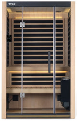 A light brown colored home sauna that fits 2 people. There are lights on inside and the lights are yellow.