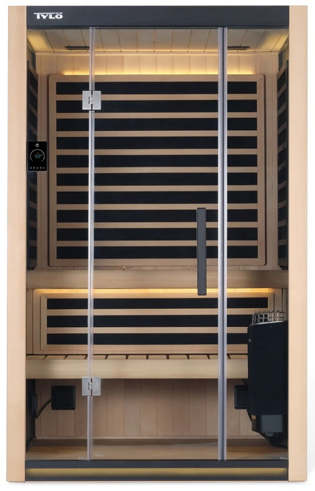 A light brown colored home sauna that fits 2 people. There are lights on inside and the lights are yellow.