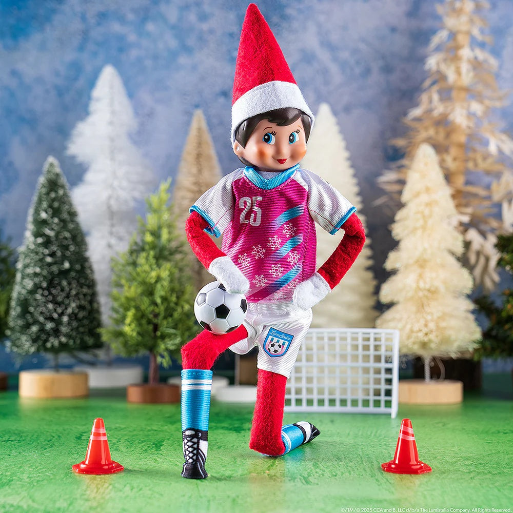 This is a lifestyle image showing a Scout Elf kneeling in front of the soccer net and wearing the uniform.