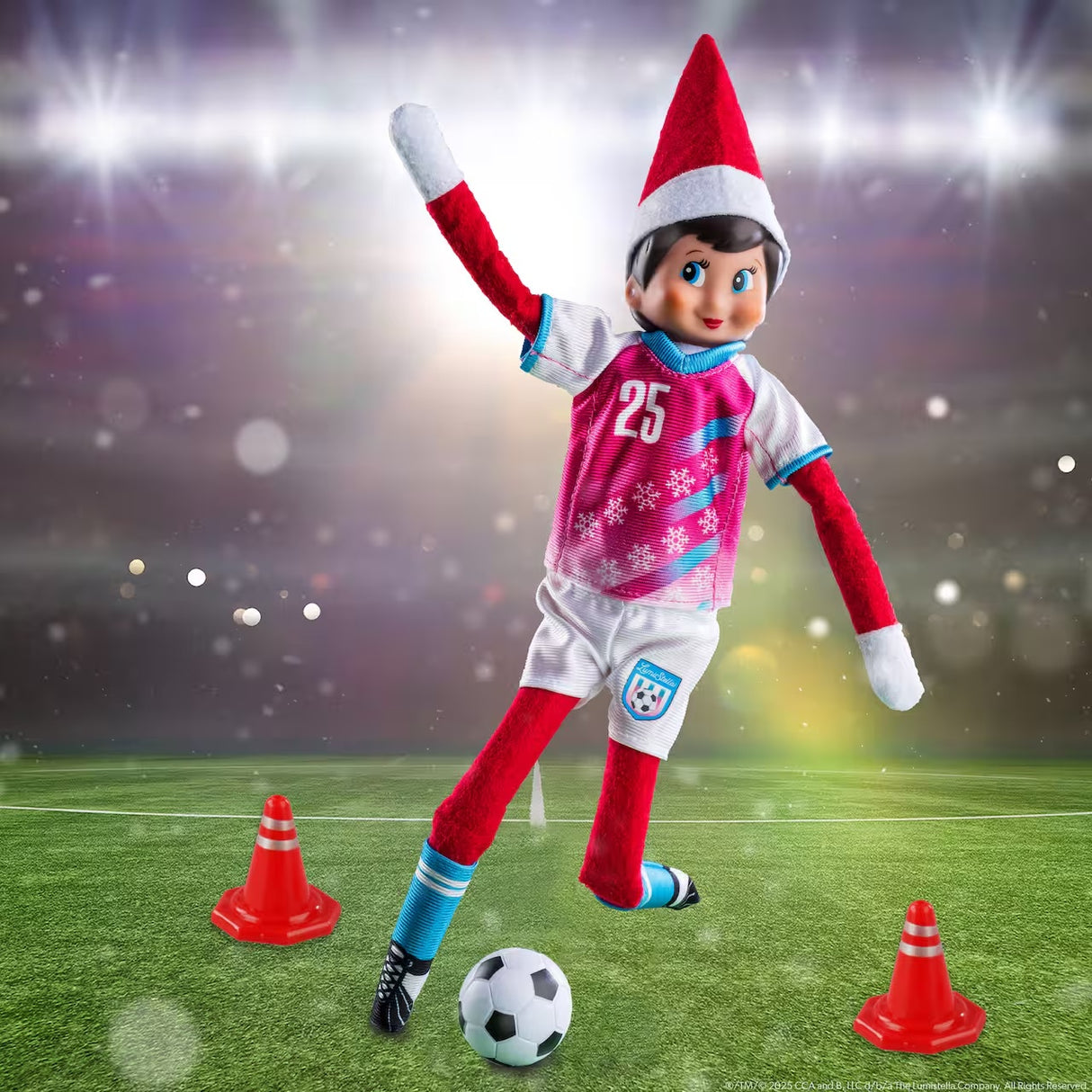 This is a lifestyle image showing a Scout Elf about to kick the soccer ball through two orange cones.