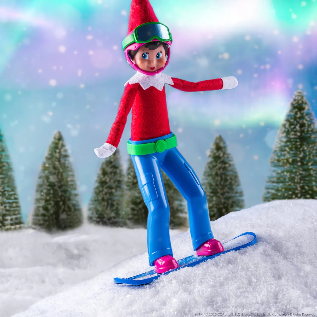 This is a lifestyle image showing a Scout Elf snowboarding down a faux snow hill with snow covered trees in the background.