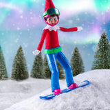 This is a lifestyle image showing a Scout Elf snowboarding down a faux snow hill with snow covered trees in the background.
