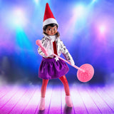 This is a lifestyle image making it look like this Scout Elf in the Pop Star outfit is on a stage with bright lights behind her.