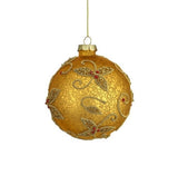 This image shows the round ornament. It has a gold base with beaded gold swirly flower designs. Inside the flowers, there are red accents.