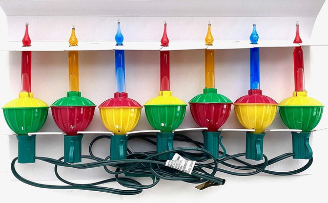 This image shows the seven bubble lights that come in this package. Three of them have red lights with a yellow and green base. Two of them have orange lights with a green and red base. Two of them have blue lights with a red and yellow base.