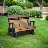 A cedar brown and black colored glider bench in a grassy backyard.