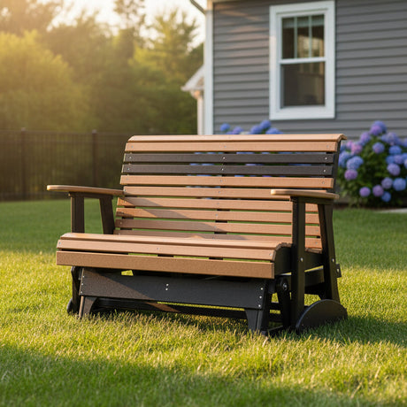 This is a lifestyle image showing this classic glider bench in a grassy backyard on a sunny day.