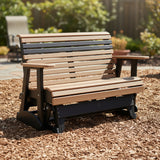 This is a lifestyle image showing this classic glider bench on a patio made of woodchips.