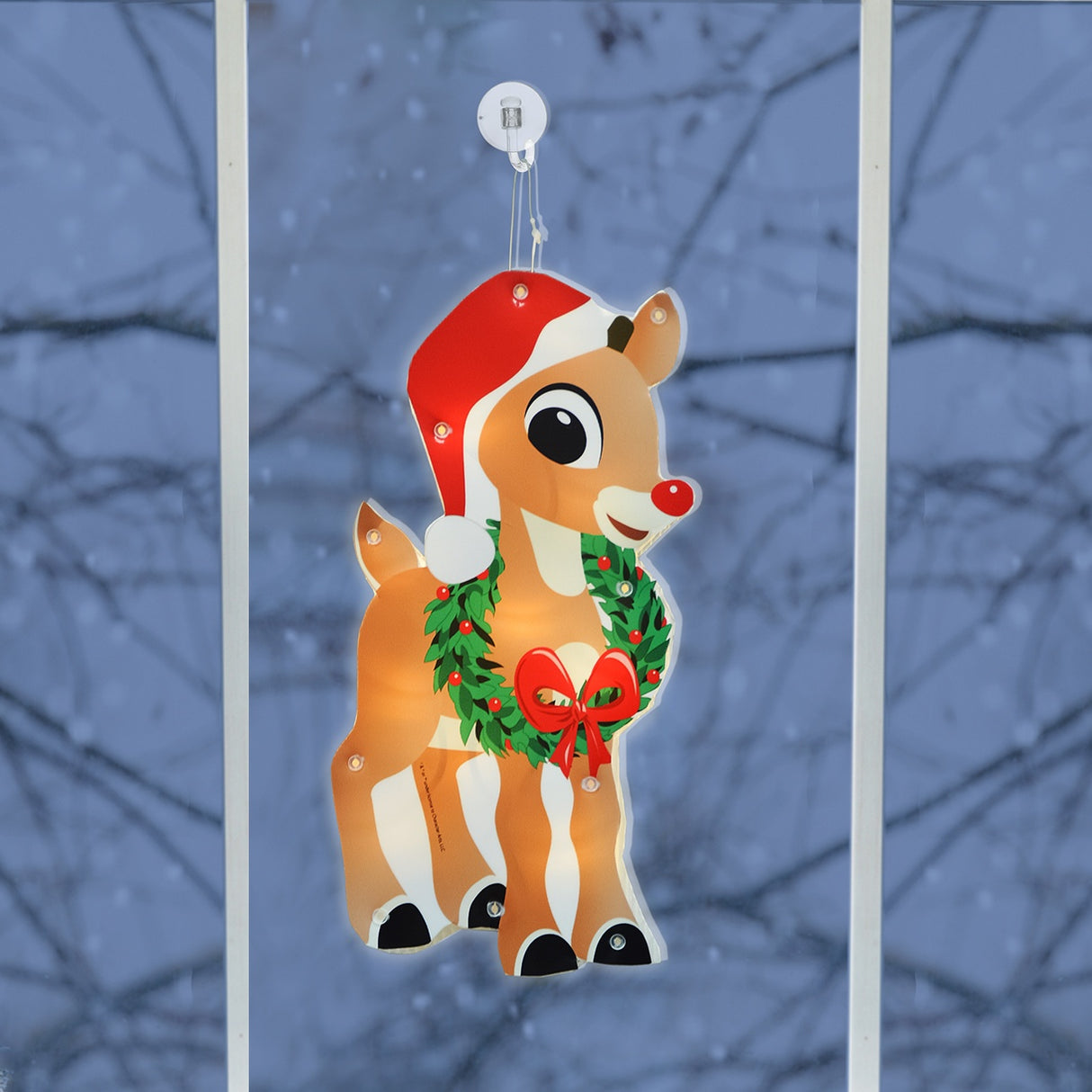 This is a lifestyle image showing this Rudolph decoration hanging in a window.