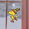 This is a lifestyle image showing the Woodstock decoration hanging in a window.