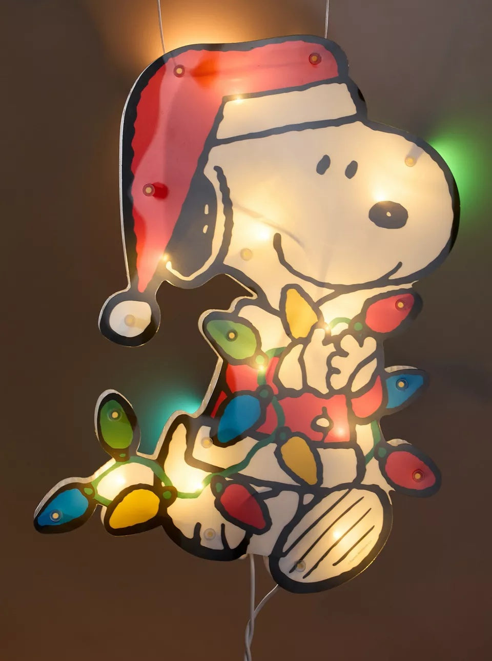 This is a lifestyle image showing this Snoopy item with the LED lights on.