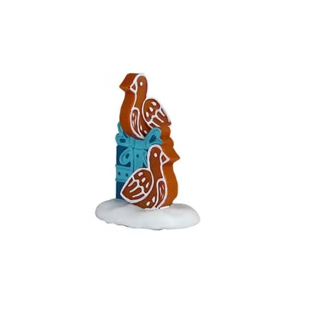 This figurine is shaped like two doves sitting by a blue present.