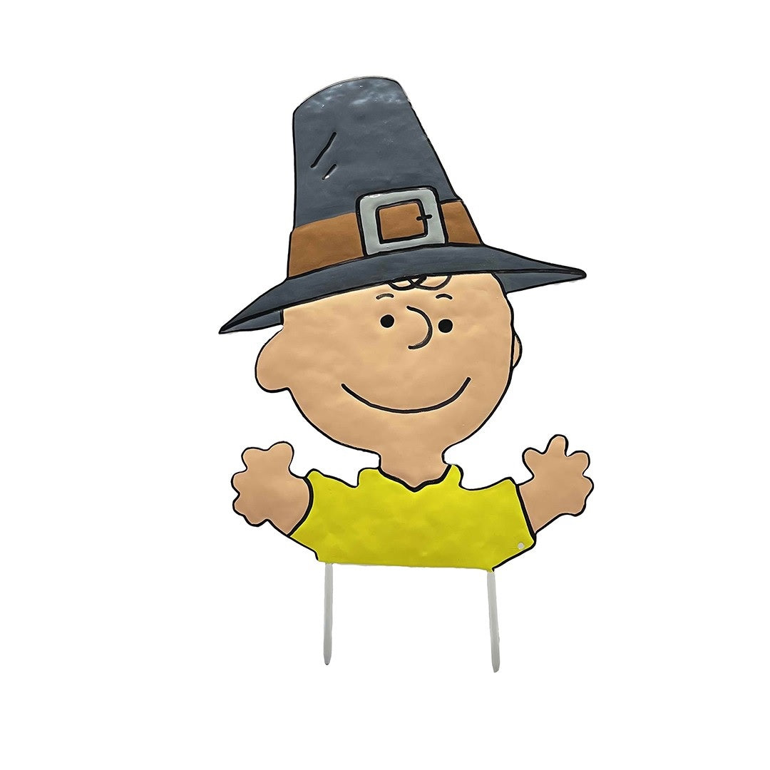 This is an up close view of the pumpkin press-in decoration. Designed to look like Charlie Brown from the famous Peanuts cartoons. He's wearing a black and brown pilgrim hat and his classic yellow shirt.