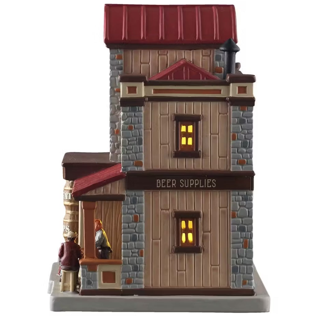 This is the other side of the building. The awning reads "BEER SUPPLIES." There are two windows with light coming through. You can see the bartender standing at the bar and the back of the man sitting on the stool.