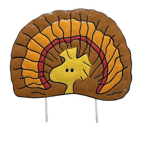 This is an up close view of the pumpkin press-in decoration. Designed to look like the yellow bird from the Peanuts cartoons: Woodstock. He has brown, red and orange feathers behind him so he looks like a turkey.