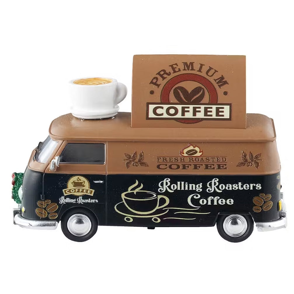 This is a different view of the truck. It reads "PREMIUM COFFEE," "FRESH ROASTED COFFEE" and "ROLLING ROASTERS COFFEE." On the roof of the truck, there's a big statue of a cup of coffee.