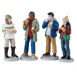 This is a set of four Lemax figurines designed to look like a group of people eating.
