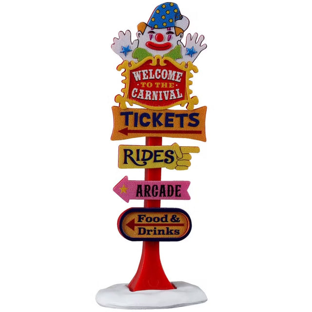 This is a Lemax Carnival sign. It reads "WELCOME TO THE CARNIVAL. TICKETS (to the left.) RIDES (to the right). ARCADE (to the left). FOOD & DRINKS (to the left)." There's a smiling clown on top.