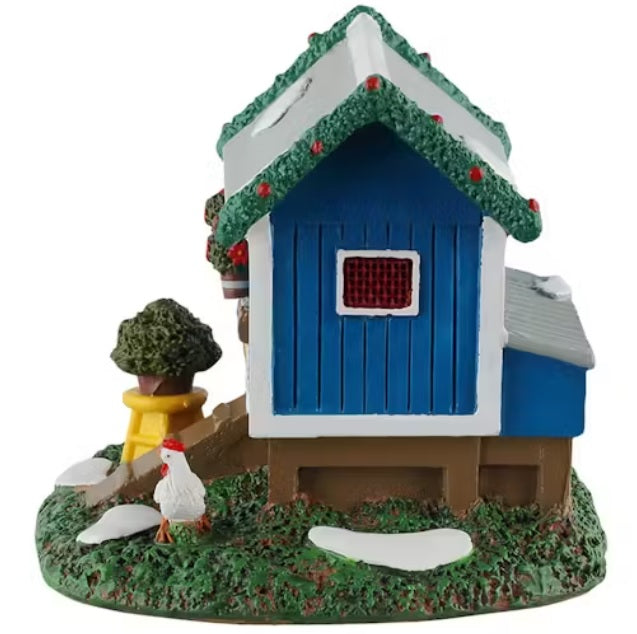 This is a different angle of this table accent. There's a chicken standing in the grass.