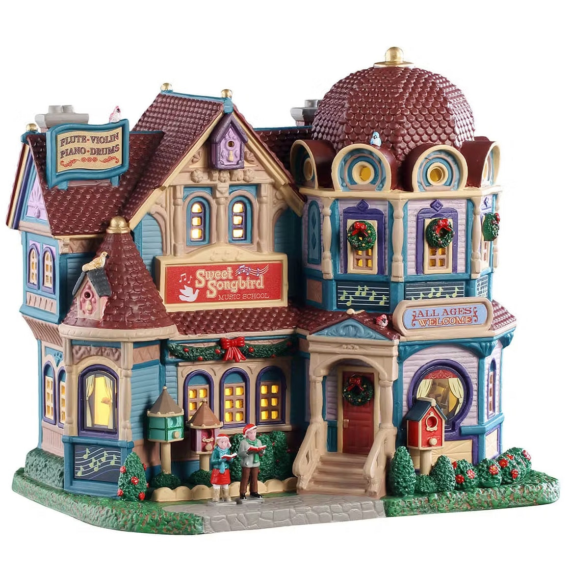 This is a Lemax lighted building designed to look like a very unique mansion turned into a music school. There are lots of intricate details. There's a sign on the roof that reads "FLUTE, VIOLIN, PIANO, DRUMS." The windows are decorated with wreaths. There's a garland hanging above the windows near the front porch. There are two children on the stone sidewalk, they're wearing Santa hats and singing. There's a cute red birdhouse next to a bunch of bushes near the front door.