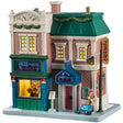 This is a Lemax lighted building designed to look like a multi-story brick shop. There's decorated garland on the roof. Lights are shining through the windows. On the left side, there's a window you can look through and see someone playing the guitar. There's a man wearing sunglasses and holding a saxophone on the sidewalk next to an open instrument case.