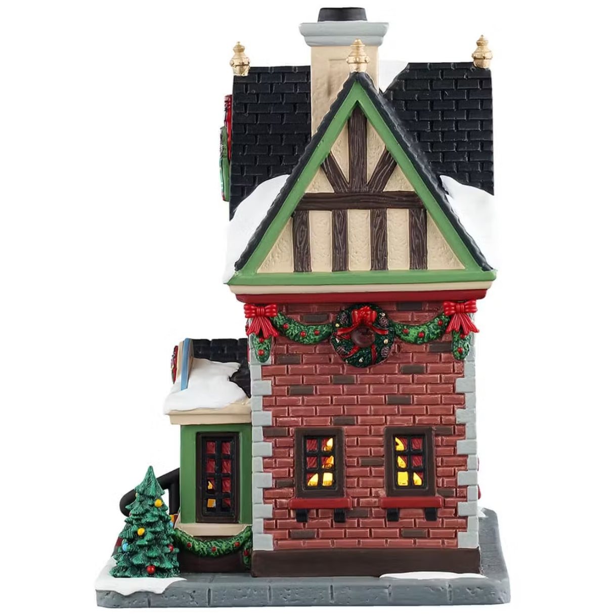 This is the other side of the building. There's snow on the roof and on the sidewalk. There's decorated garland hanging on the wall and around the windows. 