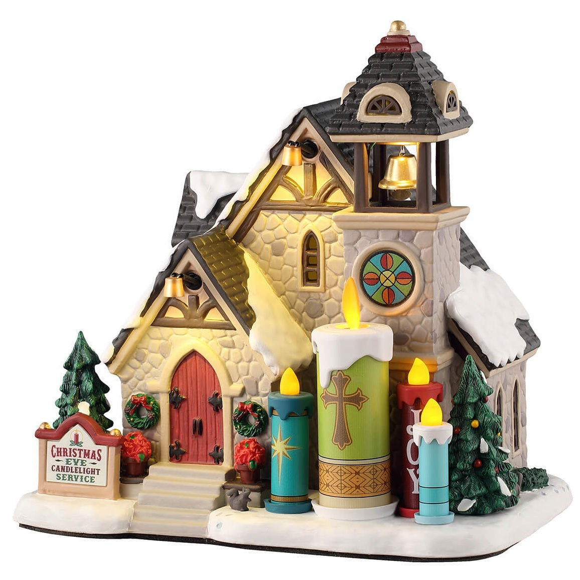 This is a Lemax lighted building designed to look like a stone church. There's a bell tower and a circular glass-stained window. In front of the church, there are four large candle statues. There's snow on the roof and on the ground.
