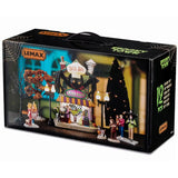 This is the box that this Lemax House Set comes in. It's showing off: four figurines, three spooky trees, two lampposts, one lighted building and two adaptors.