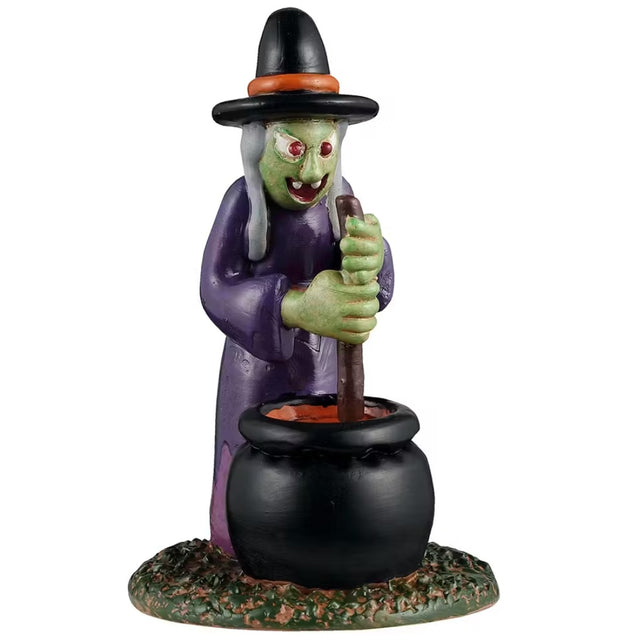 This is a Lemax Spooky Town figurine designed to look like an inflatable witch decoration. She's got a black and orange hat, a purple cloak, gray hair and red eyes. She's stirring the cauldron that's in front of her.
