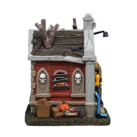 This is the side of this Lemax building showing off one of the boarded up windows and the two skulls that are on the side for decoration.