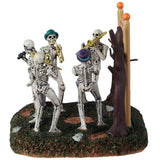 This is a different angle of the Lemax Spooky Town Jazz Festival. There are two skeletons playing trombones and two skeletons playing saxophones and one singing into a microphone.