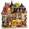 This is a Lemax Spooky Town building facade designed to look like a large mansion turned into a place where you could go for a palm reading, a meeting with a fortune teller or a séance. Behind the building you can see the moon with a bunch of bats flying in front of it.