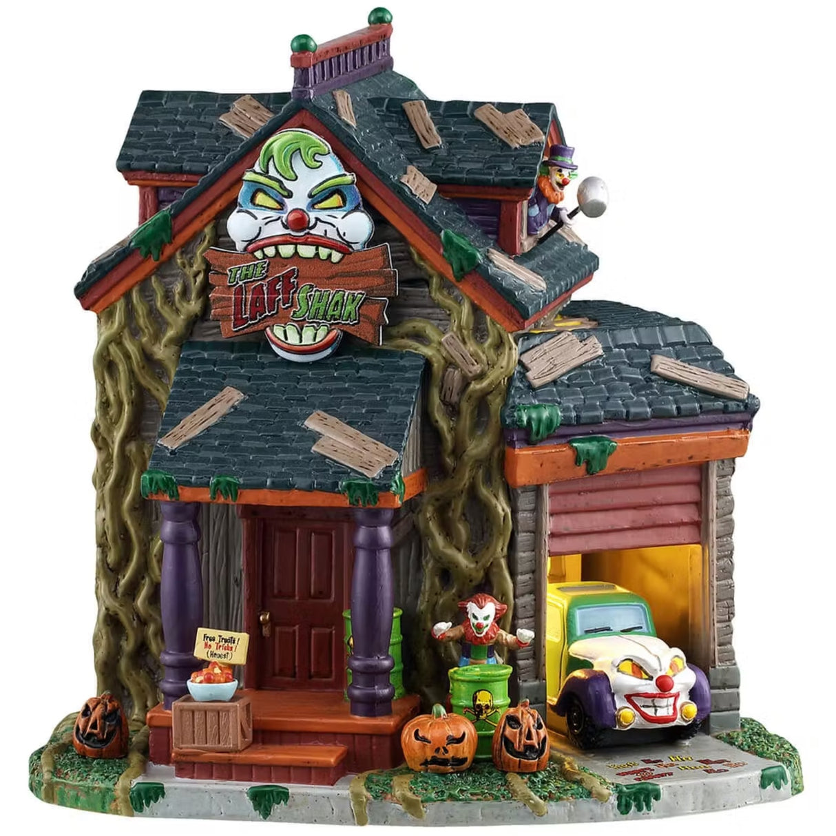 This is a Lemax Spooky Town lighted building designed to look like a rundown home. There are wooden boards all over the roof, vines growing all over and green slime everywhere. There's a sign above the front door that's shaped like a clown's head and it reads "THE LAFF SHAK." There's a bowl of candy on the front porch and jack-o-lanterns everywhere. Next to the garage door, there's a clown jumping out of a biohazard barrel. Inside the garage, there's a car with a clown head on the front bumper.