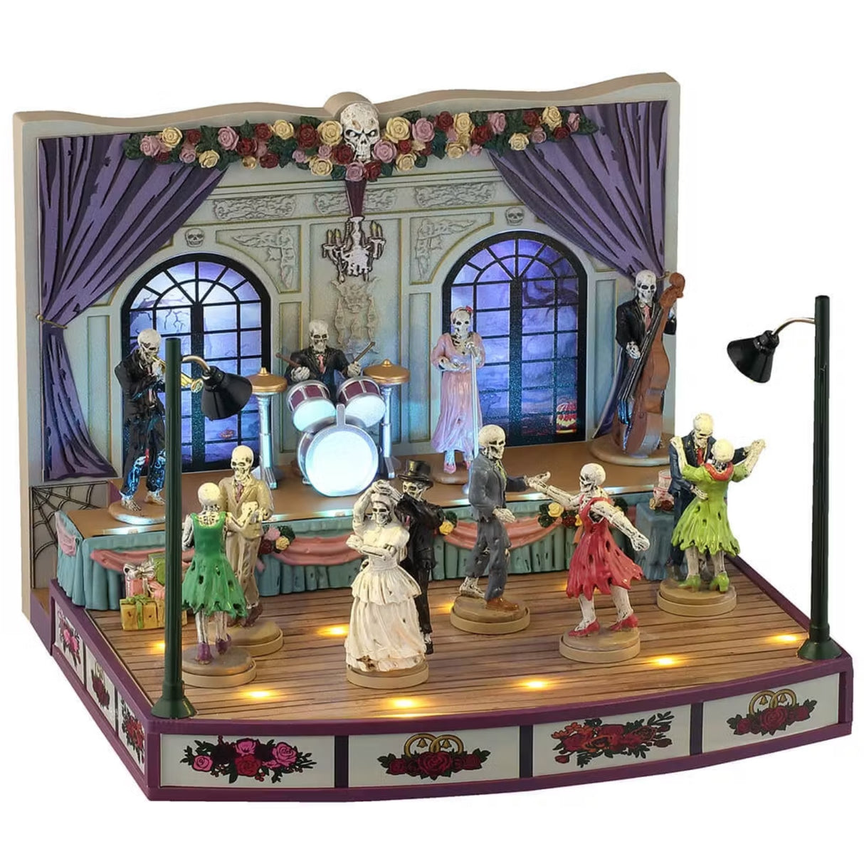 This is a Lemax Spooky Town Sights and Sounds building designed to look like a wedding hall where a bunch of skeletons are dancing.