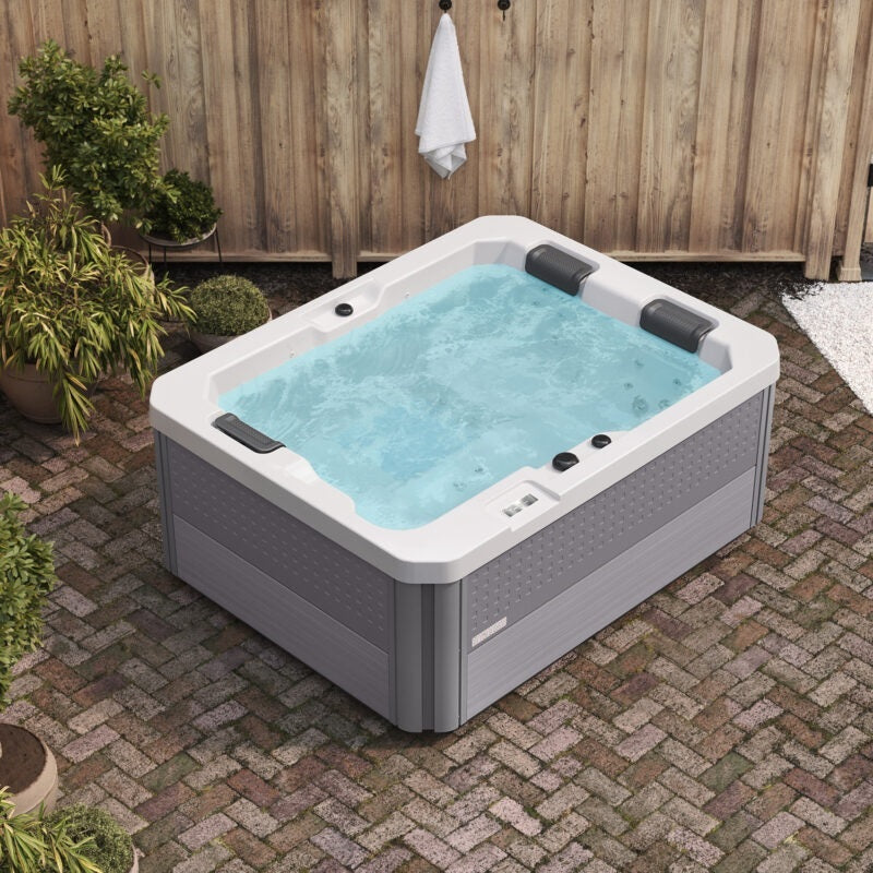 This is a picture from above. The three person hot tub is filled with water.