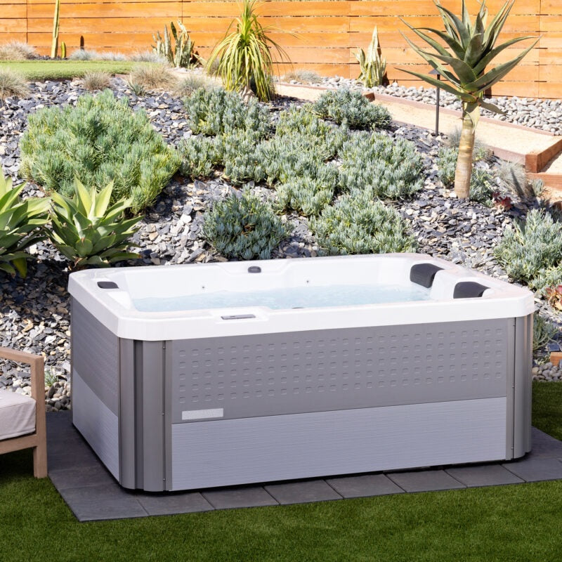 This is a lifestyle image of the hot tub in an exotic looking backyard.