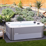 This is a lifestyle image of the hot tub in an exotic looking backyard.