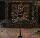 This is a lifestyle image showing the tree outside in front of a house.