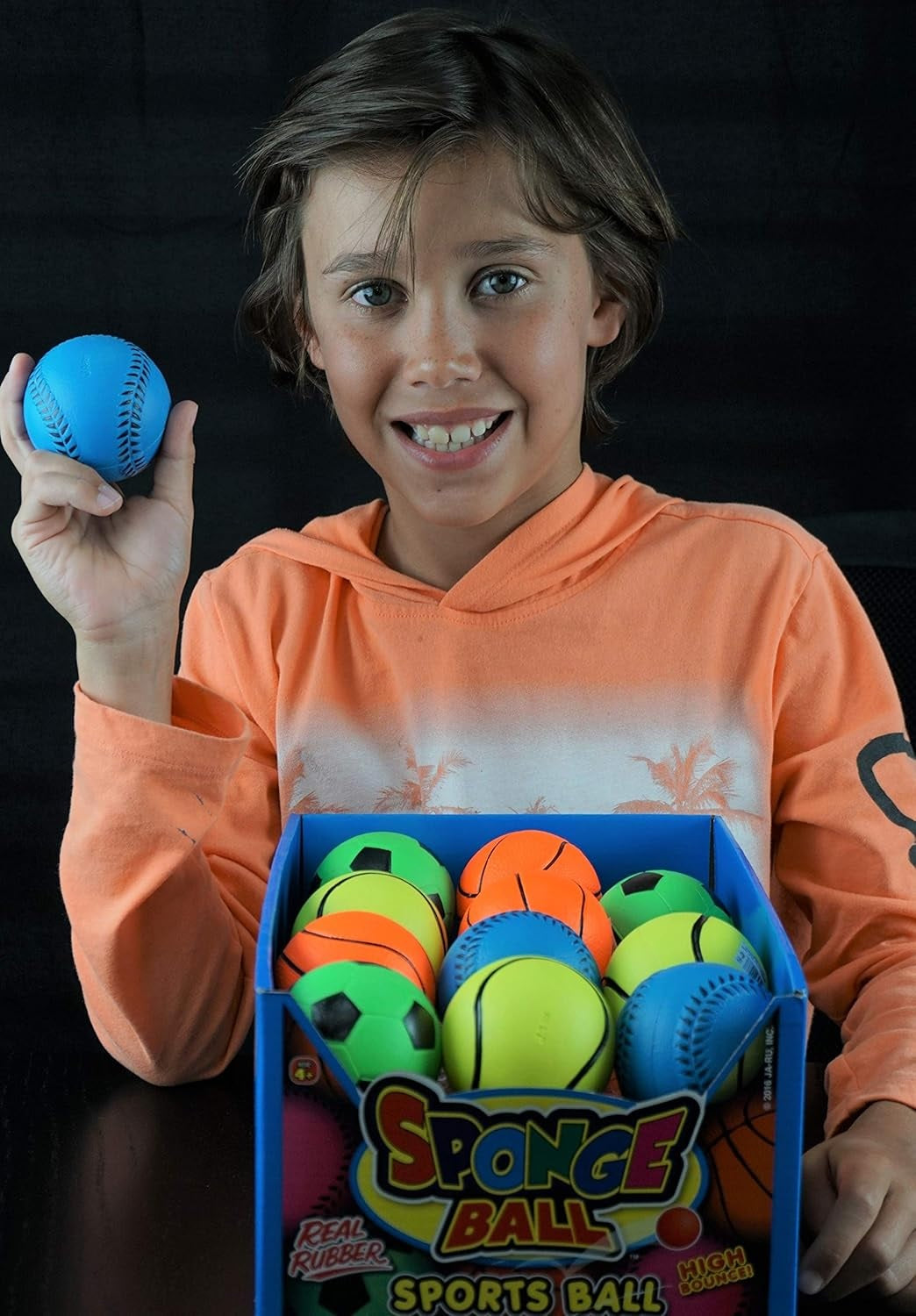This image shows boy holding the blue baseball.