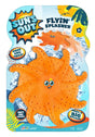 This image shows the orange color option for this flyin' splasher pool toy. The packaging reads "Sun's Out Flyin' Splasher. Soak and toss! Make a big splash! Soft and squishy." This orange option features a face in the middle. It has two large, curious eyes and a small goofy smile. There's also a small yellow star above the right eye.