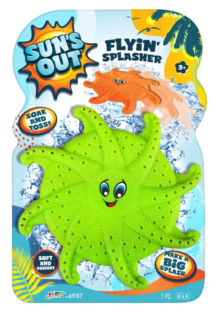 This image shows the green color option for this flyin' splasher pool toy. The packaging reads "Sun's Out Flyin' Splasher. Soak and toss! Make a big splash! Soft and squishy." This green option features a face in the middle. It has two large, blue eyes and a smile big enough to see the red tongue.