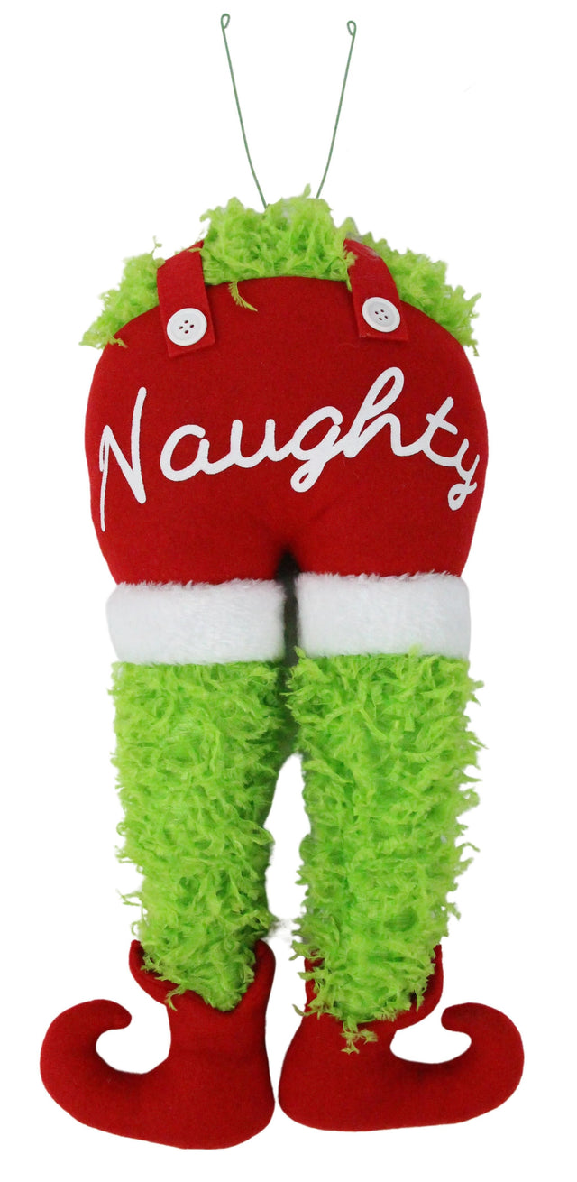 This image shows a tree decoration shaped like a furry, green body bent over. He's wearing red overalls with white cuffs. It reads "NAUGHTY" in white cursive on his behind. He's also wearing red elf shoes.