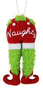 This image shows a tree decoration shaped like a furry, green body bent over. He's wearing red overalls with white cuffs. It reads "NAUGHTY" in white cursive on his behind. He's also wearing red elf shoes.