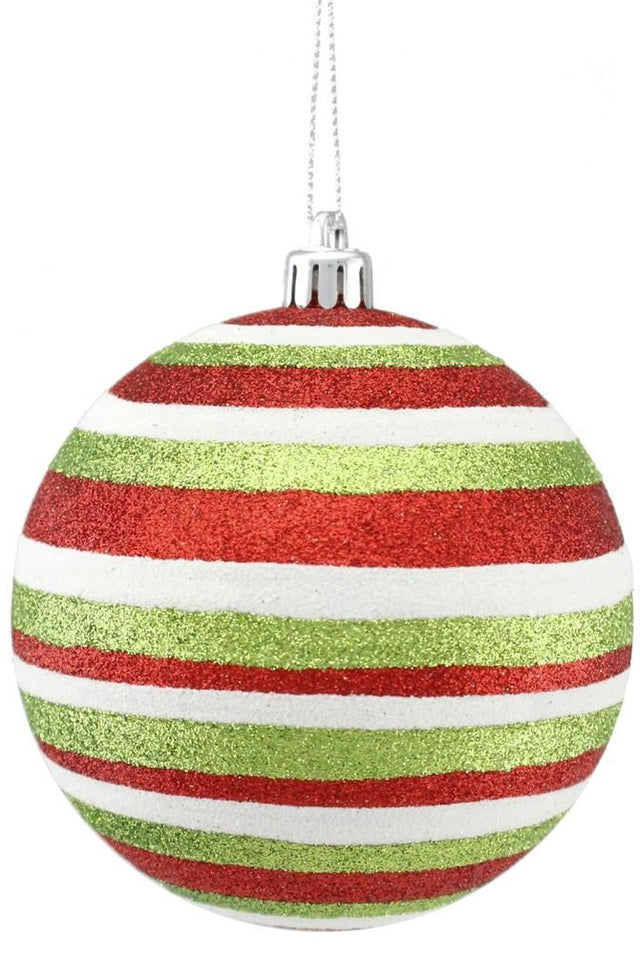 This image shows a round ornament covered in red, white and lime green glitter stripes.