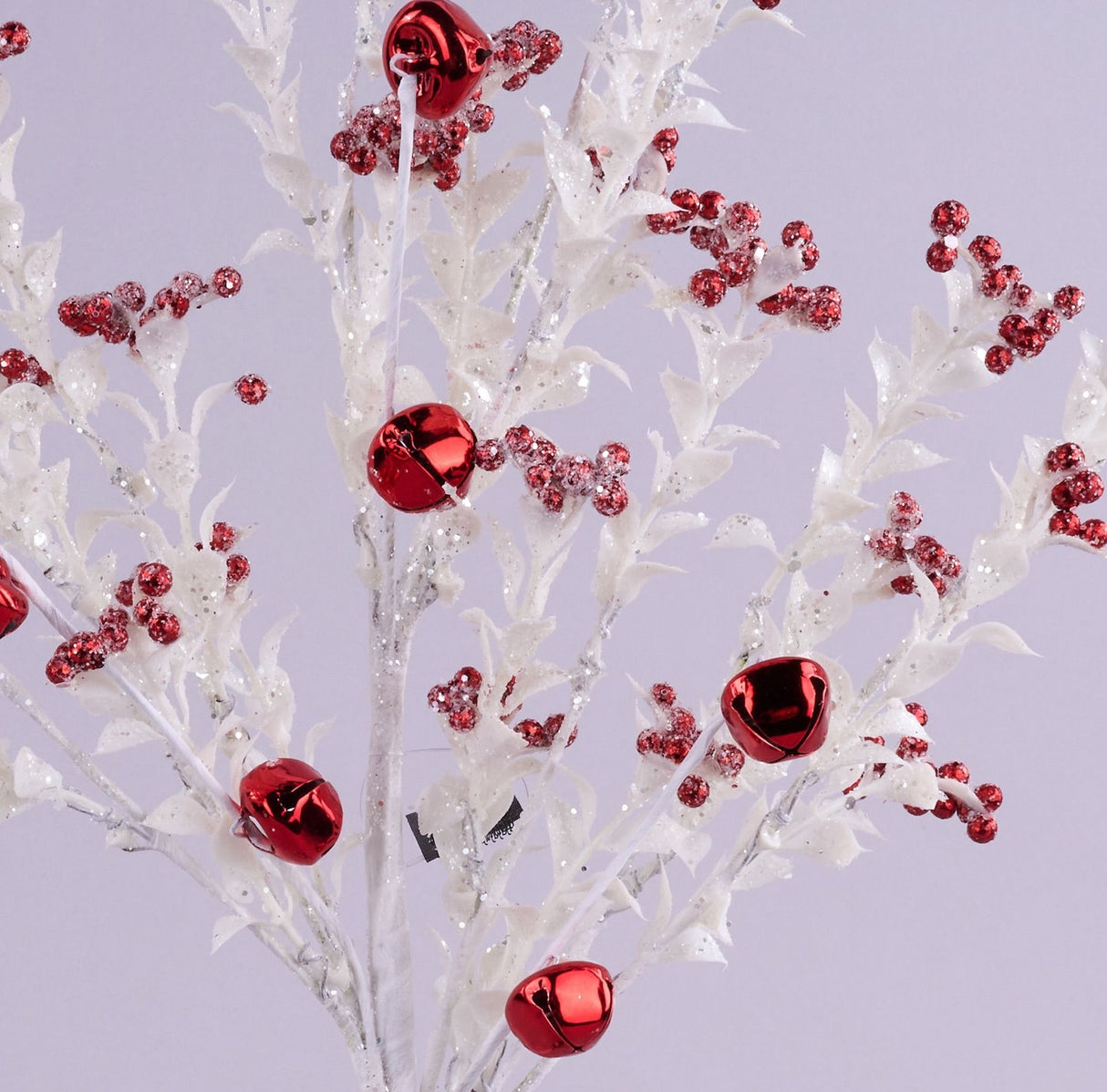 This is an up close view of the white glitter branches and the different sized red jingle bell berries.