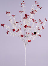 This image shows this pick spray up against a light purple background. The pick is a white stem with glittered white branches with small glitter leaves on them. Some of the branches are decorated with red jingle bells, in both small and large sizes.