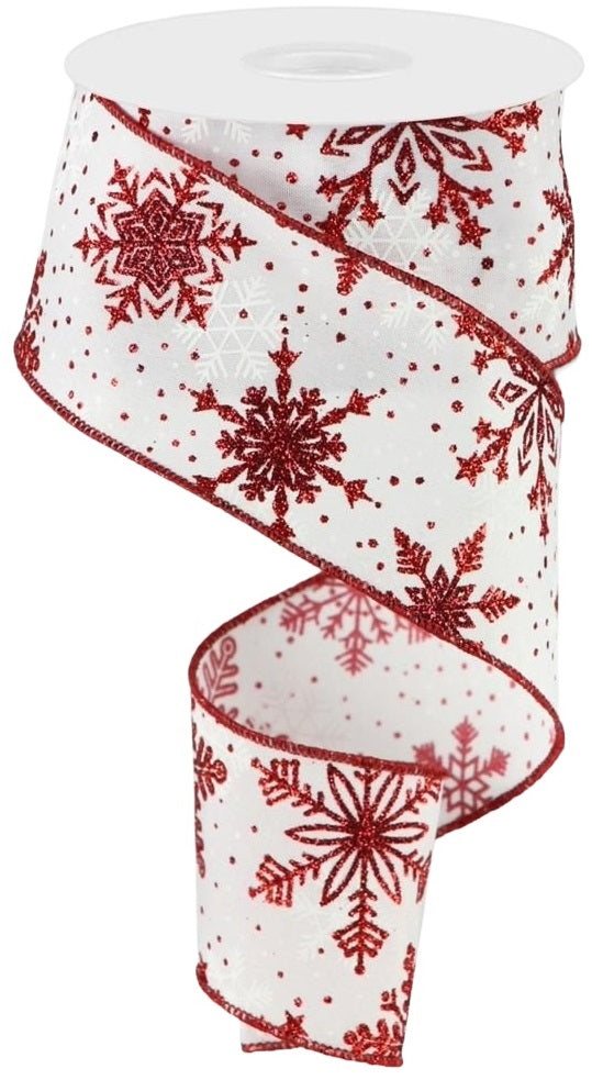 This image shows a white polyester ribbon decorated with snowflakes of different sizes and shapes. The snowflakes are red, burgundy and white. There are also red polka-dots.