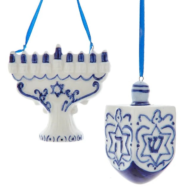 One ornament is shaped like a white menorah with blue candles. One ornament is shaped like a blue and white dreidel. 