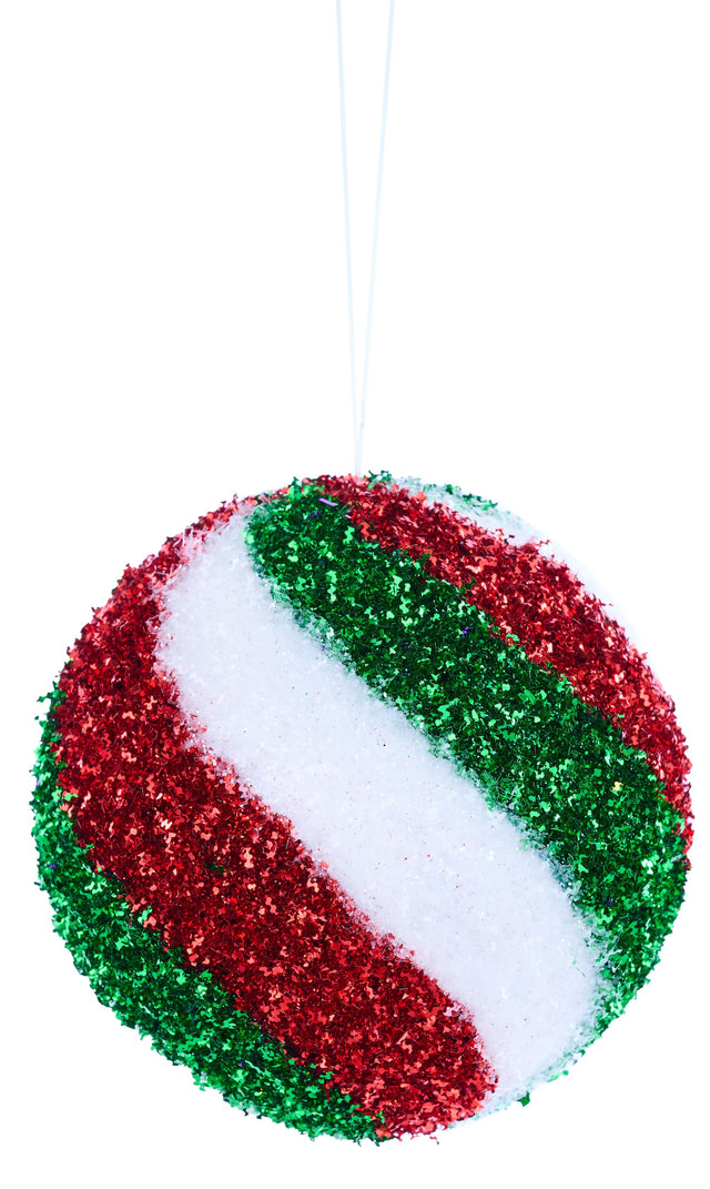 This image shows a round ornament decorated with red, white and emerald green colored swirls.